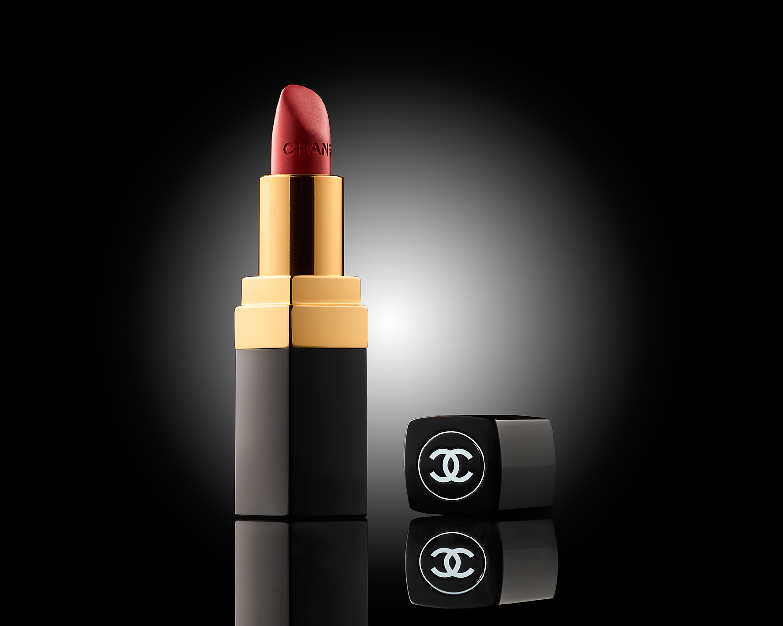 Chanel lipstick on black glow background