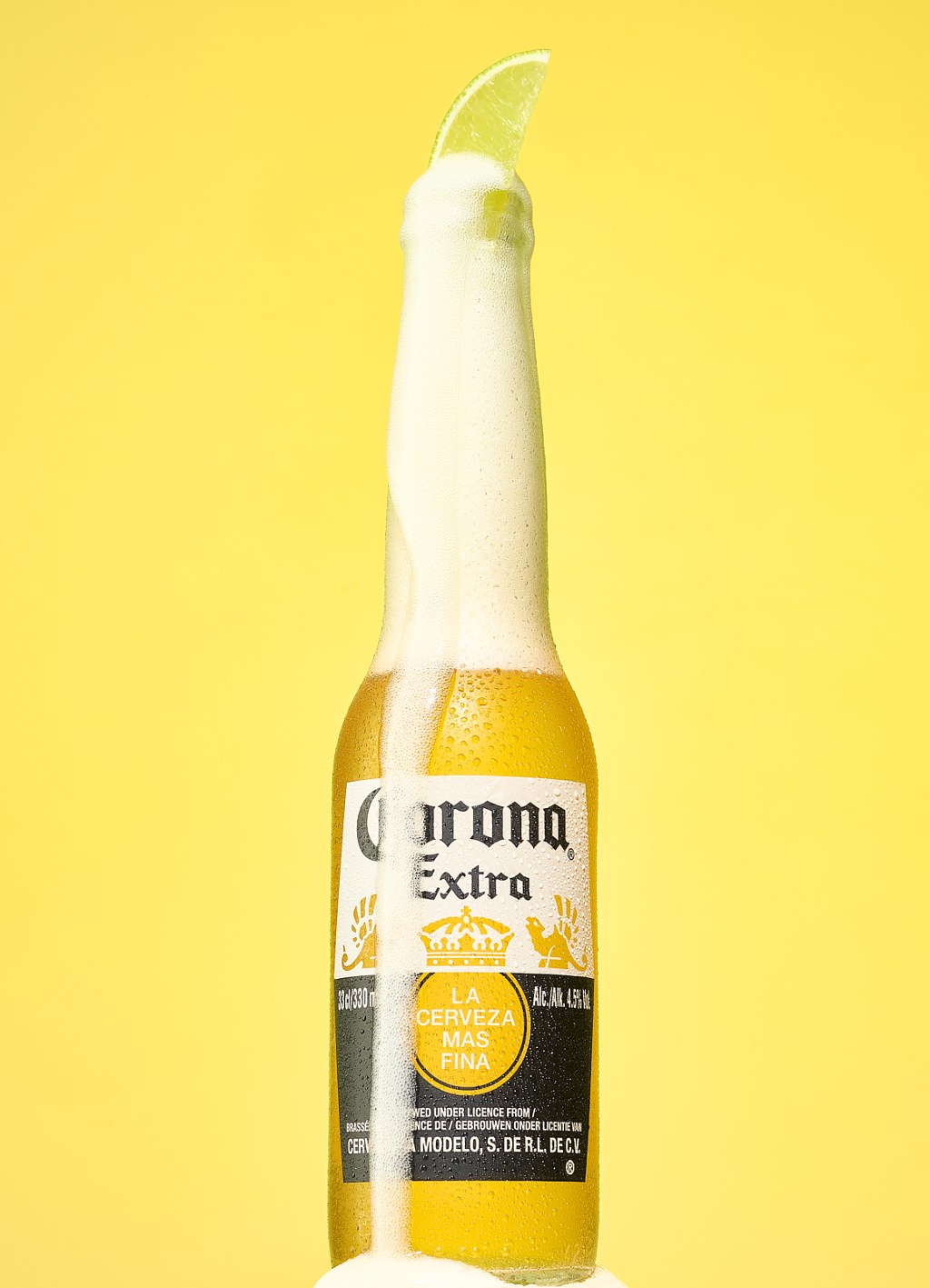 Corona beer bottle with lime wedge overflowing