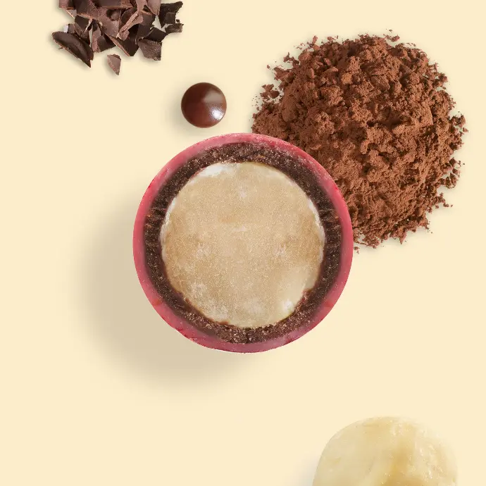 Cut red Macolat with a pile of cocoa powder